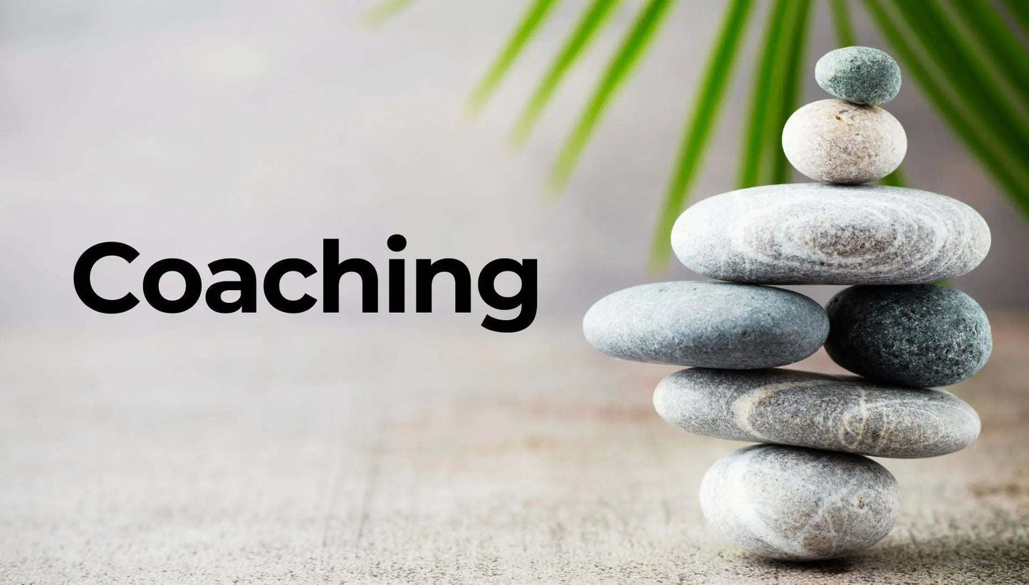 Stack of balanced stones with coaching text symbolizing professional coaching and personal development